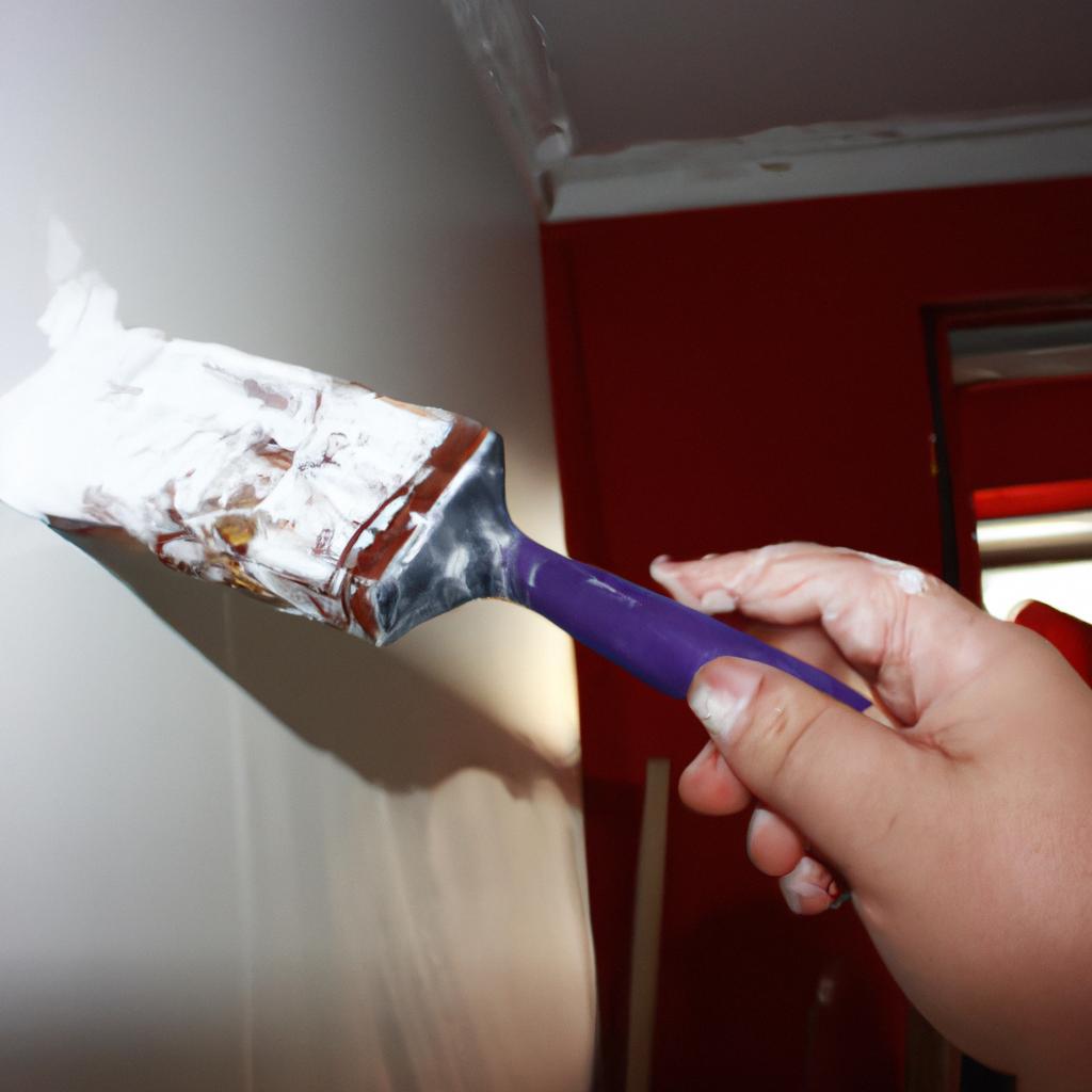 Person holding paintbrush, renovating house